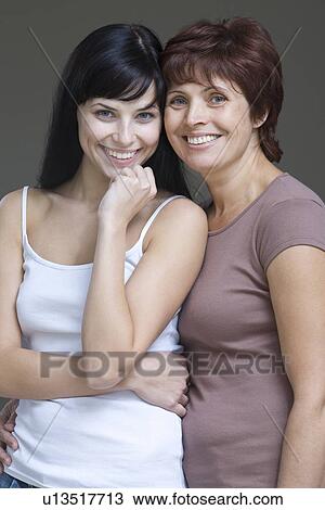 Studio portrait of young woman with mother View Large Photo Image Stock Image - Studio portrait of young woman with mother. Fotosearch