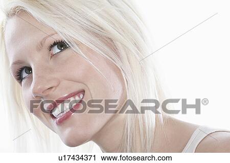 Studio shot of young woman smiling close-up View Large Photo Image Stock Image - Studio shot of young woman smiling close-up. Fotosearch