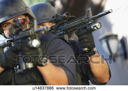 Swat officers aiming guns View Large Photo Image Stock Photograph - Swat officers aiming guns. Fotosearch