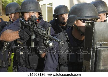 Stock Photograph - Swat officers aiming guns. Fotosearch