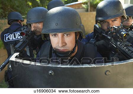 Swat officers behind shield View Large Photo Image Picture - Swat officers behind shield. Fotosearch