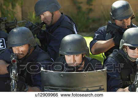 Swat officers behind shield View Large Photo Image Stock Photograph - Swat officers behind shield. Fotosearch