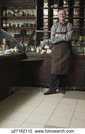 Stock Image - Tea Shop Owner in Store. Fotosearch