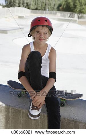 Teenage boy (13-15) with skateboard at skateboard park portrait View Large Photo Image Stock Image - Teenage boy (13-15) with skateboard at skateboard park portrait. Fotosearch