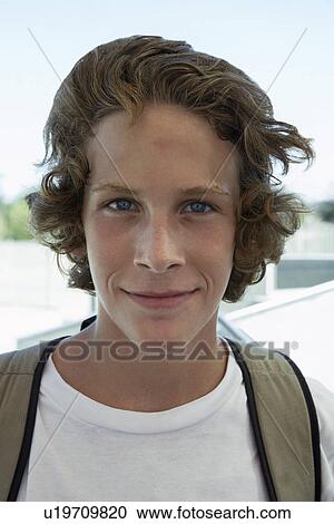 Teenage boy (16-17) smiling outdoors portrait View Large Photo Image Stock Image - Teenage boy (16-17) smiling outdoors portrait. Fotosearch