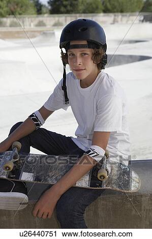 Teenage boy (16-17) with skateboard at skateboard park portrait View Large Photo Image Stock Image - Teenage boy (16-17) with skateboard at skateboard park portrait. Fotosearch