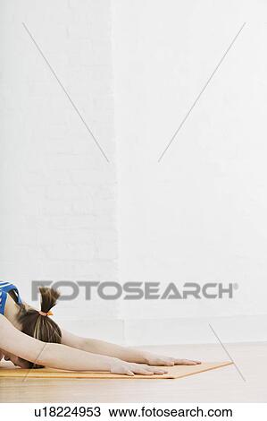 Stock Image - Teenage girl (16-17) exercising. Fotosearch