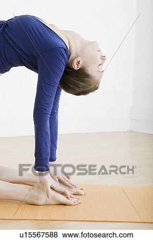 Stock Photo - Teenage girl (16-17) exercising. Fotosearch