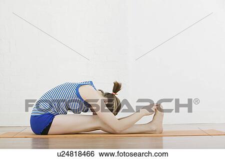 Teenage girl (16-17) exercising View Large Photo Image Stock Photograph - Teenage girl (16-17) exercising. Fotosearch