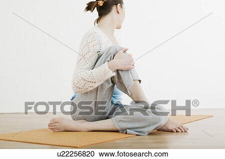 Stock Image - Teenage girl (16-17) performing yoga. Fotosearch