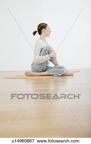 Stock Photo - Teenage girl (16-17) performing yoga. Fotosearch
