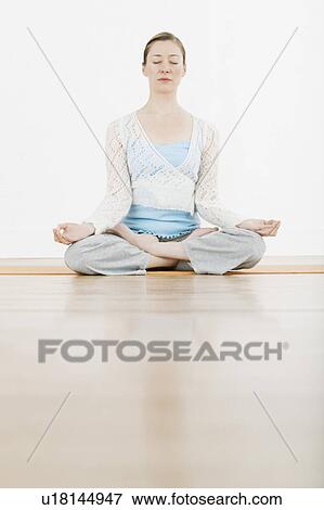 Stock Photo - Teenage girl (16-17) performing yoga. Fotosearch