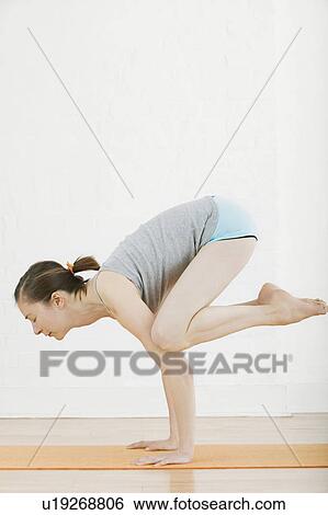 Stock Photograph - Teenage girl (16-17) performing yoga. Fotosearch