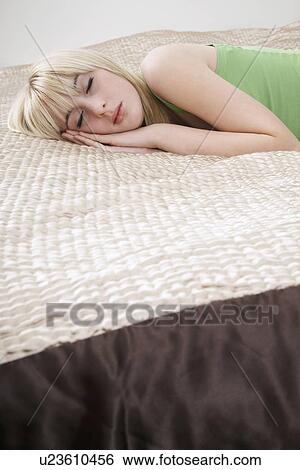 Teenage girl (16-17) sleeping on bed View Large Photo Image Stock Photograph - Teenage girl (16-17) sleeping on bed. Fotosearch