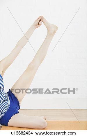 Teenage girl (16-17) stretching leg low section View Large Photo Image Picture - Teenage girl (16-17) stretching leg low section. Fotosearch