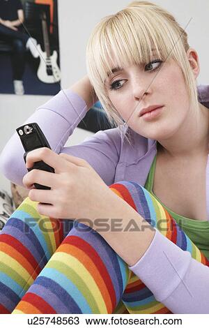 Teenage girl (16-17) using mobile phone View Large Photo Image Stock Image - Teenage girl (16-17) using mobile phone. Fotosearch