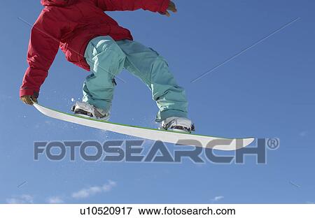 Teenage snowboarder jumping cropped View Large Photo Image Stock Photo - Teenage snowboarder jumping cropped. Fotosearch