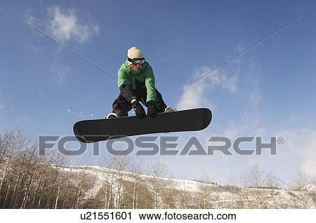 Teenage snowboarder jumping View Large Photo Image Stock Image - Teenage snowboarder jumping. Fotosearch