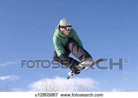 Teenage snowboarder jumping View Large Photo Image Stock Photo - Teenage snowboarder jumping. Fotosearch