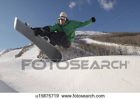 Stock Photo - Teenage snowboarder jumping. Fotosearch