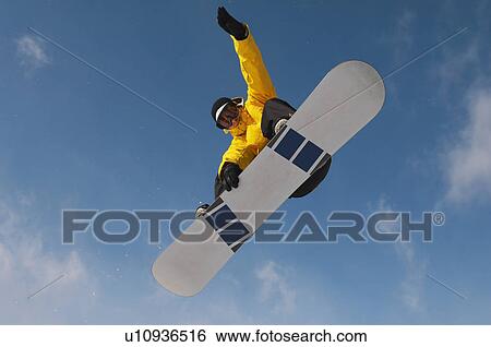 Stock Photograph - Teenage snowboarder jumping. Fotosearch