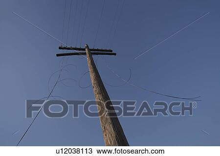 Stock Image - Telephone with cut cables low angle view. Fotosearch