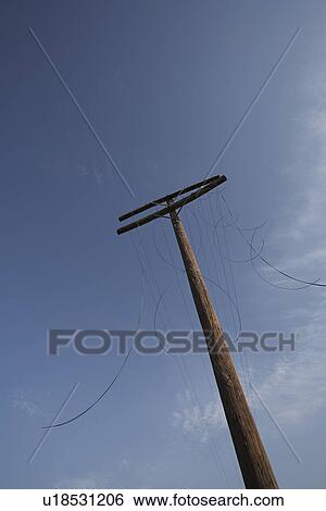 Stock Photograph - Telephone with cut cables low angle view. Fotosearch