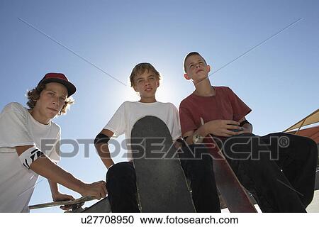 Three teenage boys (16-17) with skateboards outdoors portrait View Large Photo Image Stock Image - Three teenage boys (16-17) with skateboards outdoors portrait. Fotosearch