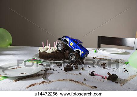 Toy car driven into birthday cake View Large Photo Image Stock Photograph - Toy car driven into birthday cake. Fotosearch