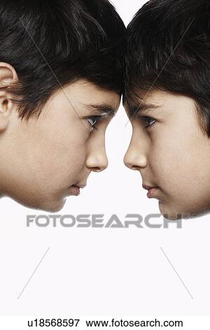 Twin boys (13-15) head to head close-up View Large Photo Image Stock Photo - Twin boys (13-15) head to head close-up. Fotosearch