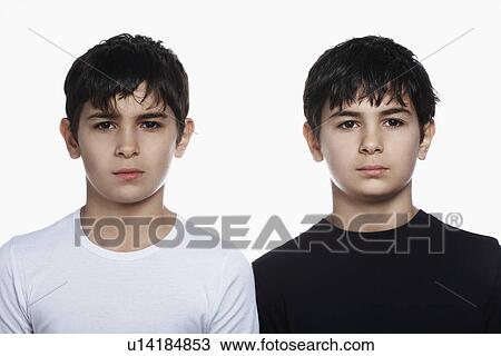 Stock Image - Twin boys (13-15) portrait. Fotosearch