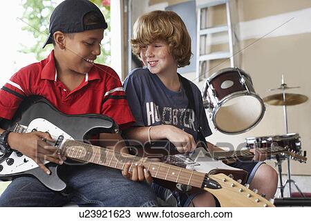 Two boys (10-12) with instruments in garage View Large Photo Image Stock Image - Two boys (10-12) with instruments in garage. Fotosearch