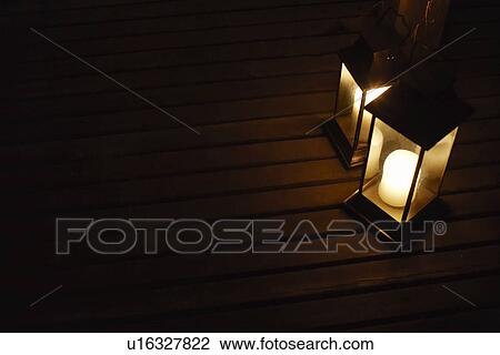 Two illuminated lanterns on deck at night View Large Photo Image Stock Image - Two illuminated lanterns on deck at night. Fotosearch