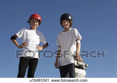 Two teenage male skateboarders (16-17) outdoors portrait View Large Photo Image Stock Image - Two teenage male skateboarders (16-17) outdoors portrait. Fotosearch