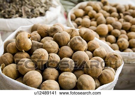 Stock Image - UAE Dubai dried lemons and other spices for sale in the spice souq in Deira. Fotosearch