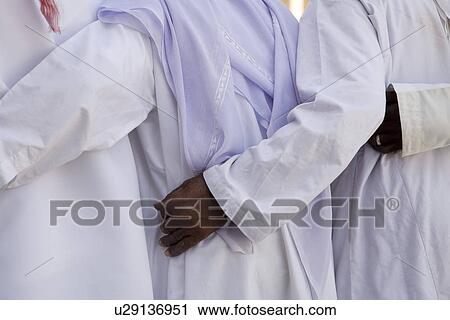 UAE Dubai group of traditionally dressed Muslim men perform a song for visitors to the Bastakia View Large Photo Image Stock Image - UAE Dubai group of traditionally dressed Muslim men perform a song for visitors to the Bastakia. Fotosearch