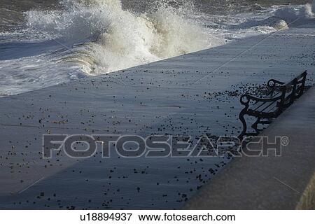 Stock Photo - Water crashing on cement pier. Fotosearch