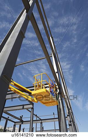 Welder working from cherry picker on warehouse construction View Large Photo Image Stock Image - Welder working from cherry picker on warehouse construction. Fotosearch