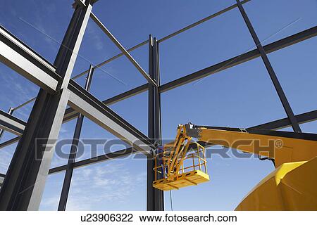 Welder working from cherry picker on warehouse construction View Large Photo Image Stock Image - Welder working from cherry picker on warehouse construction. Fotosearch