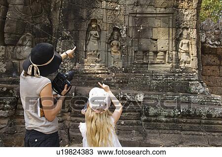 Stock Image - Woman and Girl Looking at Ancient Temple. Fotosearch