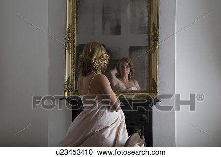 Woman dressed in quilt examining herself in mirror View Large Photo Image Stock Image - Woman dressed in quilt examining herself in mirror. Fotosearch