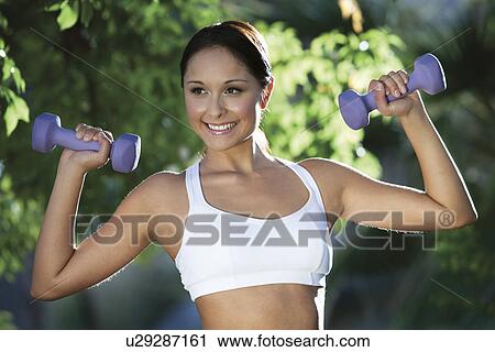 Woman exercising in park View Large Photo Image Stock Image - Woman exercising in park. Fotosearch
