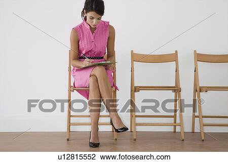 Woman in pink dress writing View Large Photo Image Stock Image - Woman in pink dress writing. Fotosearch