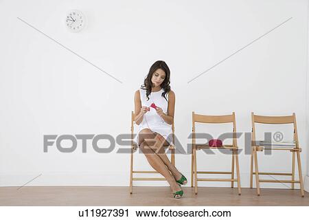Stock Image - Woman in waiting room. Fotosearch