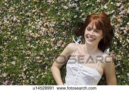 Stock Image - Woman Lying in Grass. Fotosearch