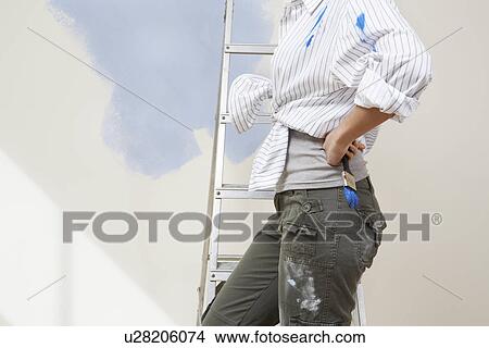 Woman painting wall mid section View Large Photo Image Picture - Woman painting wall mid section. Fotosearch