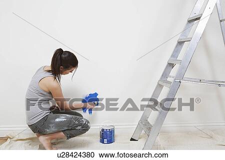 Woman painting wall View Large Photo Image Stock Image - Woman painting wall. Fotosearch