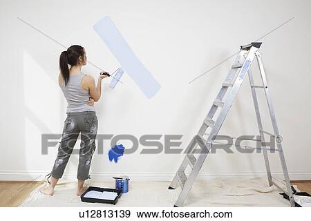 Woman painting wall View Large Photo Image Stock Photo - Woman painting wall. Fotosearch