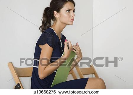 Stock Photograph - Woman sitting side view. Fotosearch