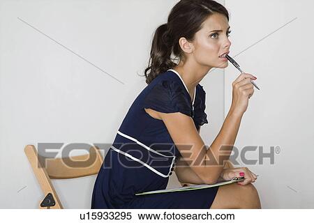 Stock Photography - Woman sitting side view. Fotosearch
